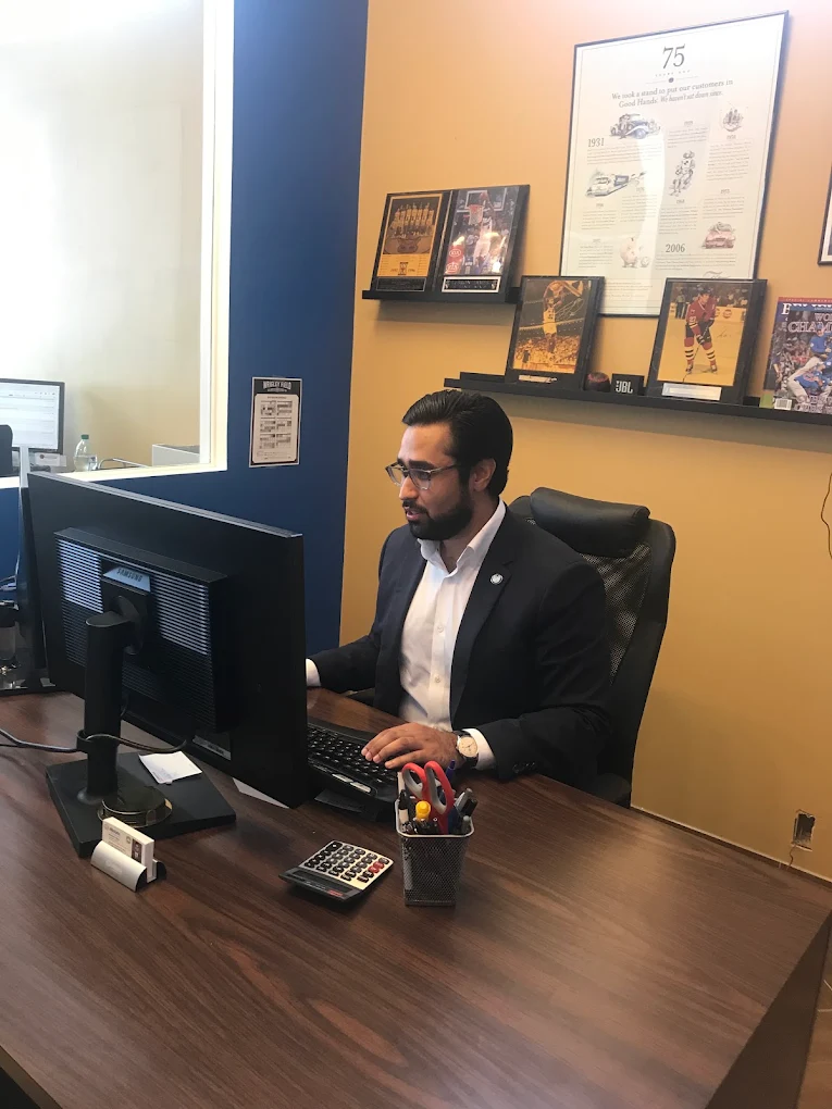 Manmeet Singh working at his desk in the Northwest Chicago Insurance office